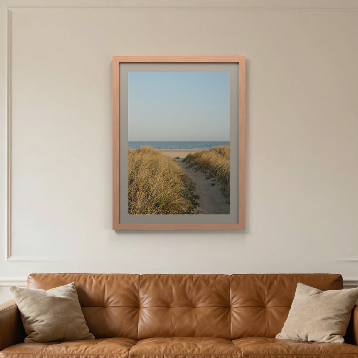 Beech picture frame with a Dawn Grey mount hanging on a living room wall