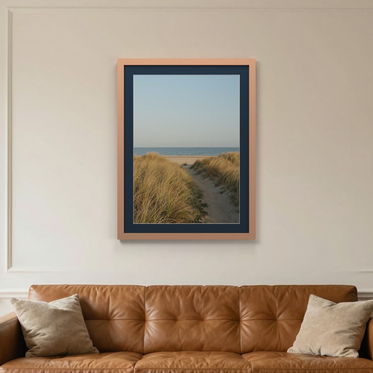 Beech picture frame with a Pacific Blue mount hanging on a living room wall