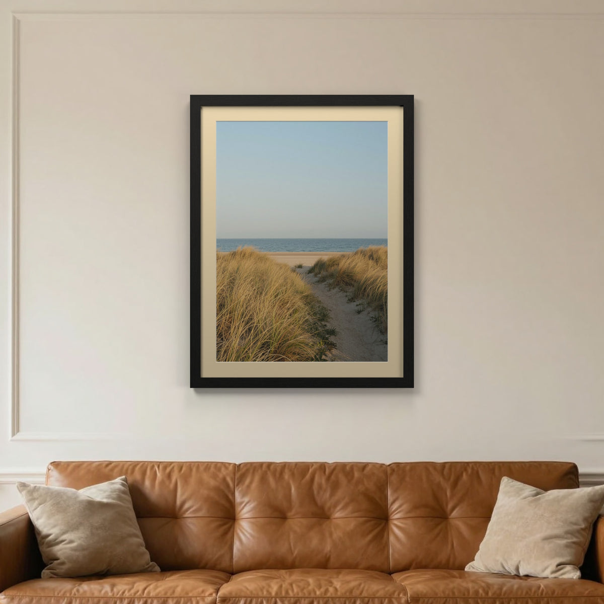 Black picture frame with an ivory mount hanging on a living room wall