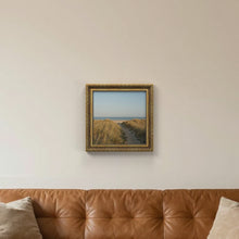 Dahlia Gold picture frame, hanging on a living room wall