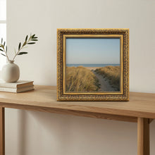 Dahlia Gold picture frame, standing on a table