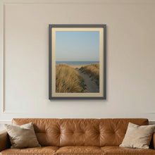 Dark Grey picture frame with an ivory mount hanging on a living room wall