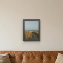 Dark Grey picture frame hanging on a living room wall