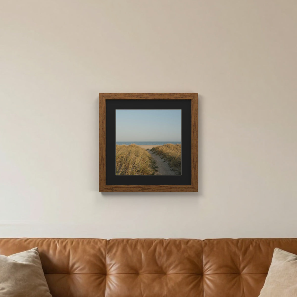 Dark Oak picture frame with a black mount hanging on a living room wall