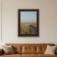 Dark Teak picture frame with a black mount hanging on a living room wall