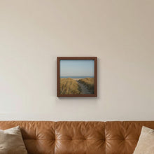 Devon Walnut picture frame hanging on a living room wall