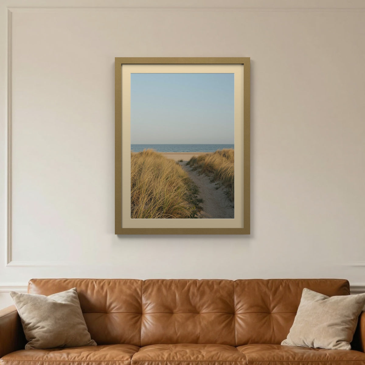 Gold picture frame with an ivory mount hanging on a living room wall