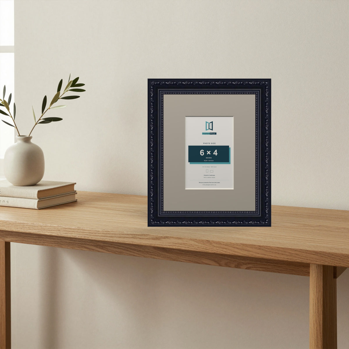Louis Black picture frame with a Dawn Grey mount standing on a table