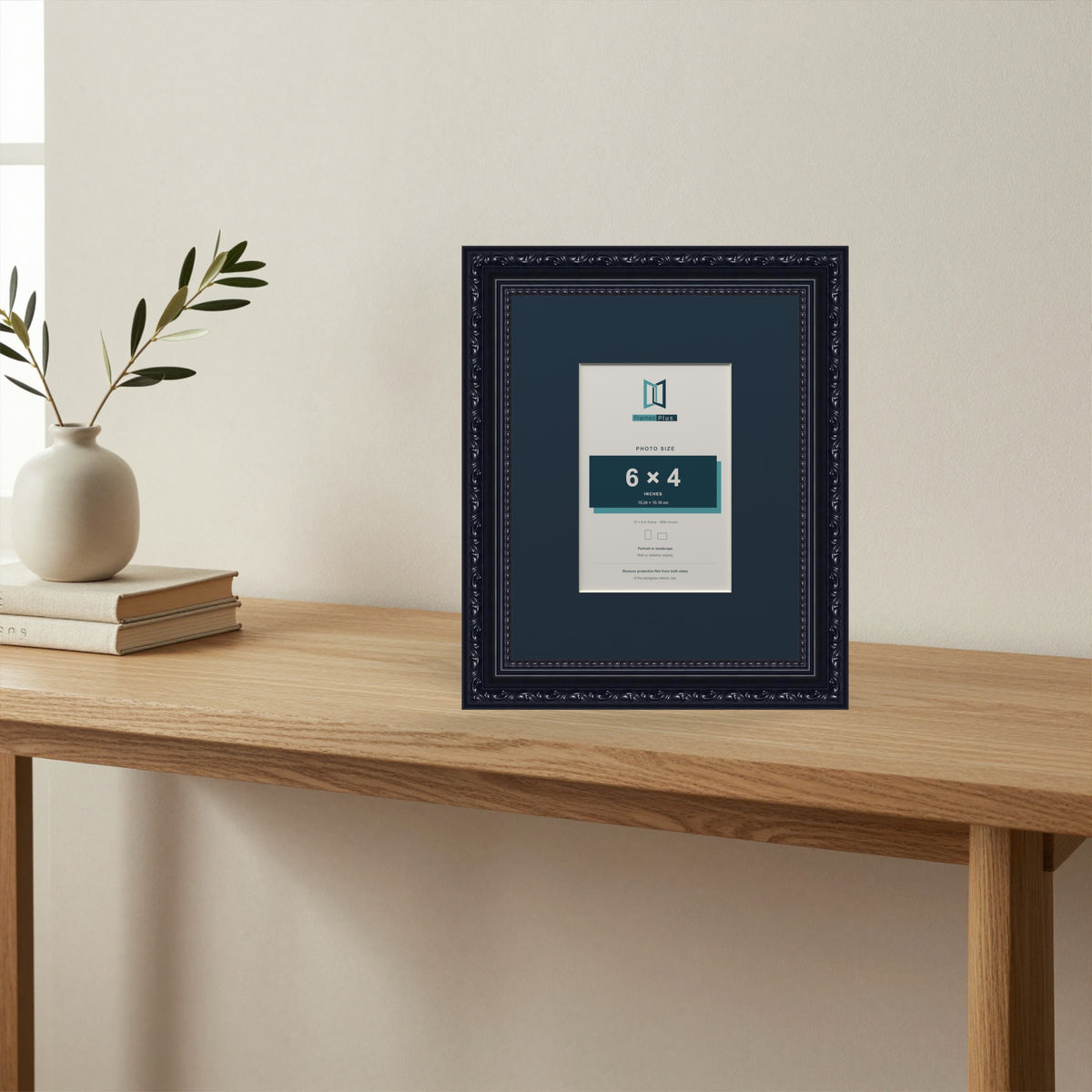 Louis Black picture frame with a Pacific Blue mount standing on a table