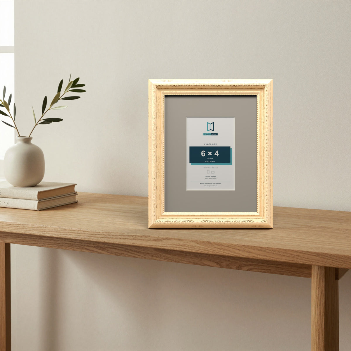 Louis Cream picture frame with a Dawn Grey mount standing on a table