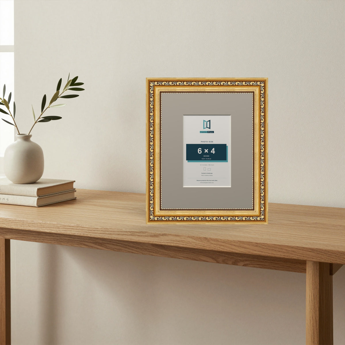 Louis Gold picture frame with a Dawn Grey mount standing on a table