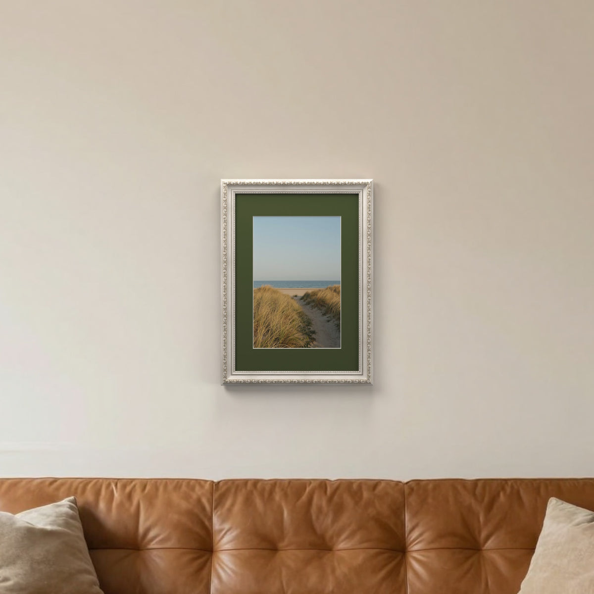 Louis Silver picture frame with a green mount hanging on a living room wall