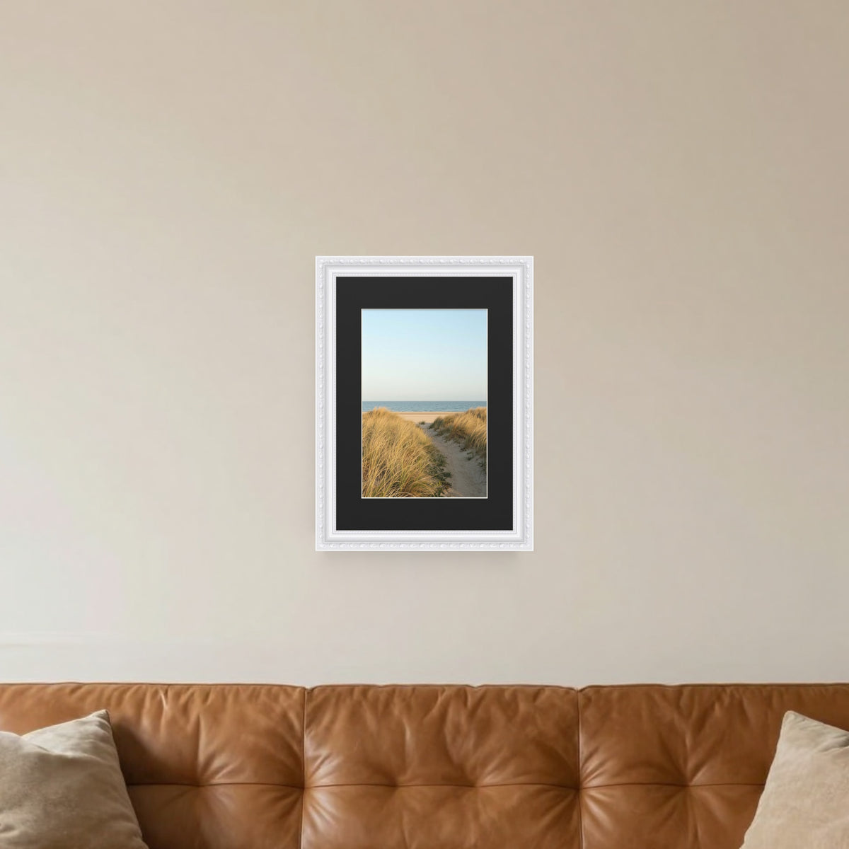 Louis White picture frame with a black mount hanging on a living room wall