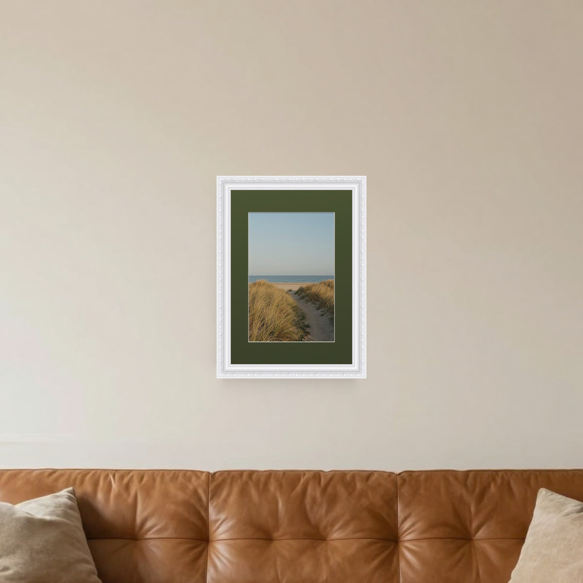 Louis White picture frame with a green mount hanging on a living room wall