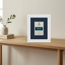 Louis White picture frame with a Pacific Blue mount standing on a table