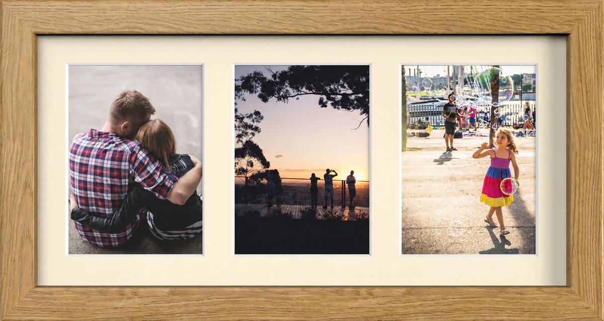 Oak Multi-Aperture Frame for 3 Photos 7x5" with Ivory Mount displaying photographs