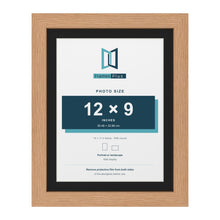 Oak 14 x 11 inch picture frame with a black mount for a 12 x 9 inch photo