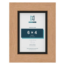 Oak 7 x 5 inch picture frame with a black mount for a 6 x 4 inch photo