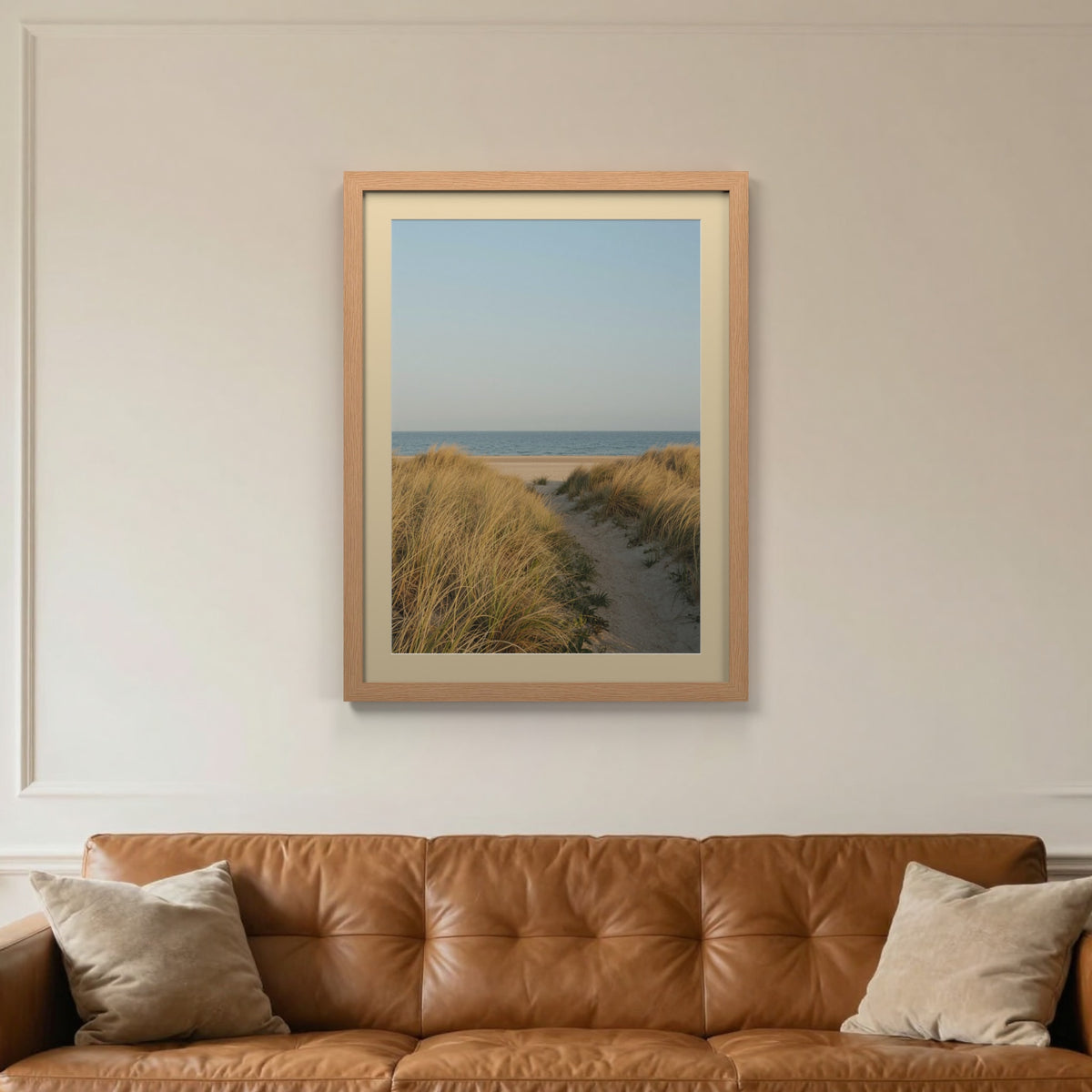 Oak picture frame with an ivory mount hanging on a living room wall