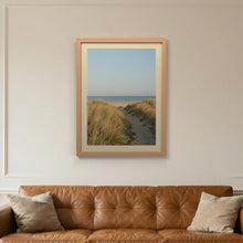 Oak picture frame with an ivory mount hanging on a living room wall