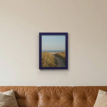 Purple picture frame hanging on a living room wall