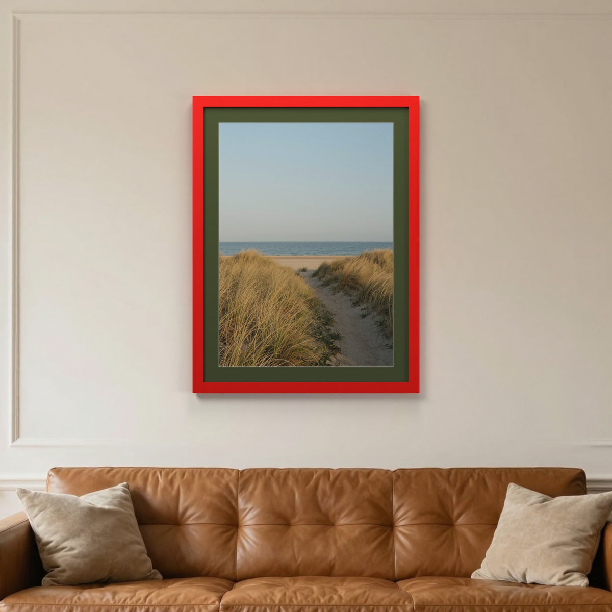 Red picture frame with a green mount hanging on a living room wall