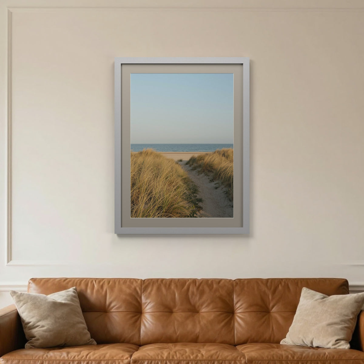 Silver picture frame with a Dawn Grey mount hanging on a living room wall