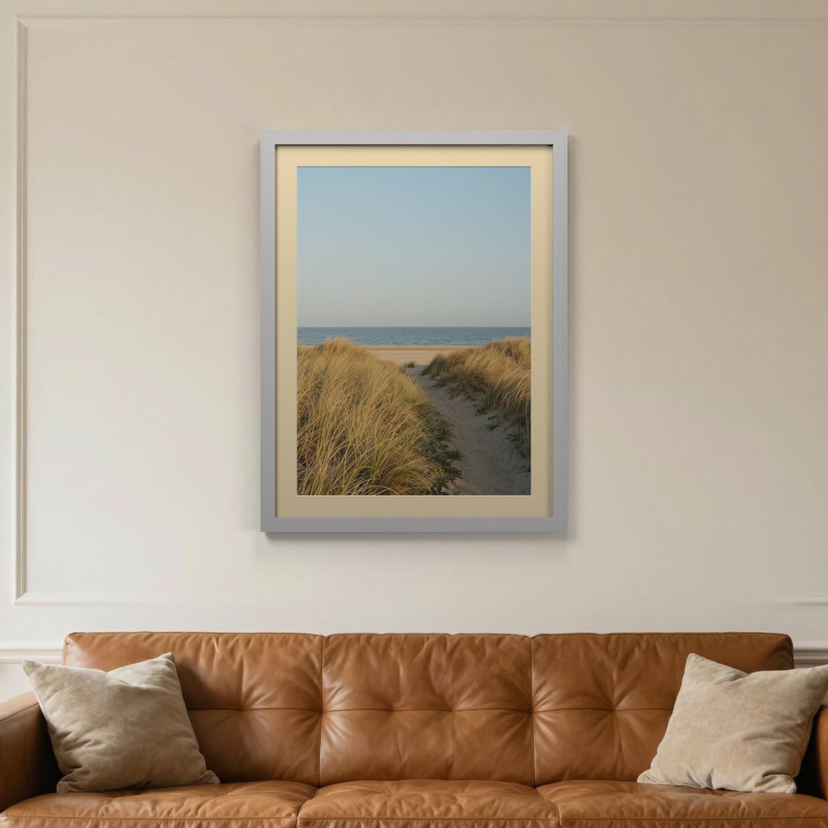 Silver picture frame with an ivory mount hanging on a living room wall