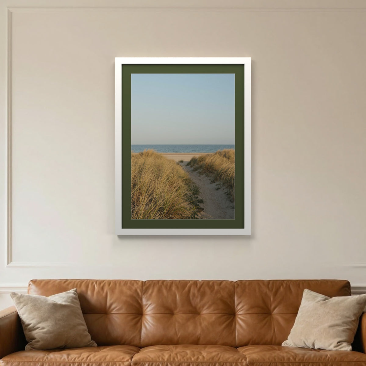 White picture frame with a green mount hanging on a living room wall