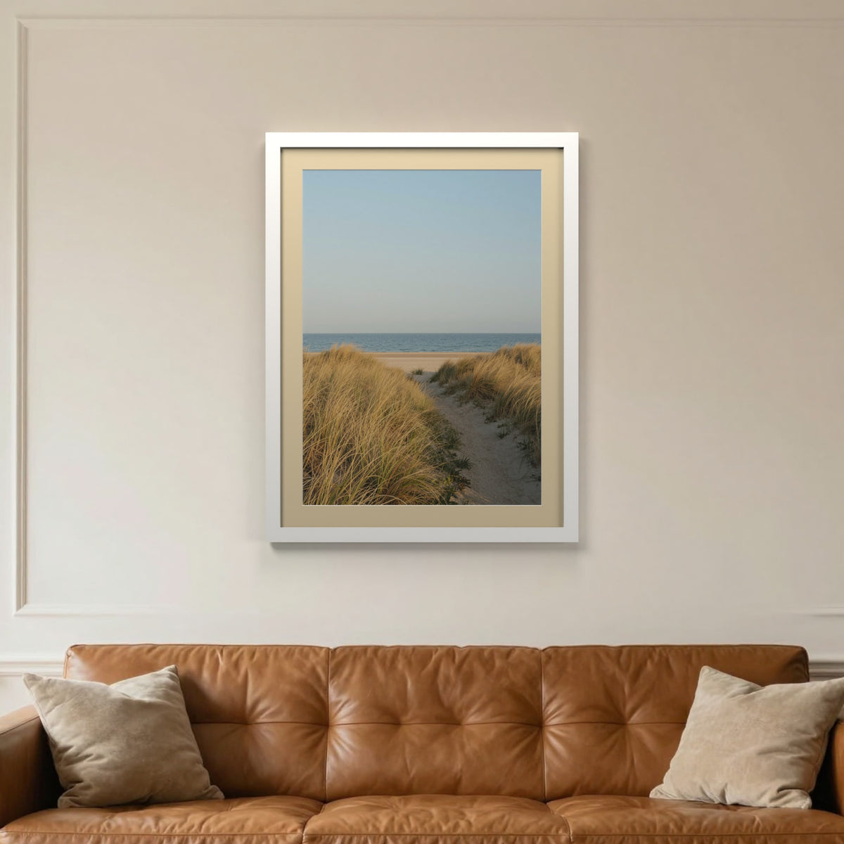 White picture frame with an ivory mount hanging on a living room wall